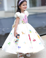 Enchanting frock featuring princesses and a fairytale castle—perfect for a magical occasion.