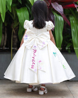 Enchanting frock featuring princesses and a fairytale castle—perfect for a magical occasion.