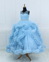 Elegant Sky Blue Ball Gown With Ruffle Detailing And Diamond Belt.
