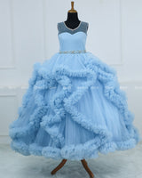 Elegant Sky Blue Ball Gown With Ruffle Detailing And Diamond Belt.