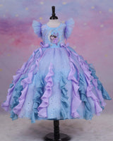 A dreamy lilac-blue fairy gown with butterfly details, side bows, and sparkling ruffles.