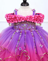 A Dreamy Cold-Shoulder Ball Gown with Flowing Layers of Lavender and Pink Tulle.