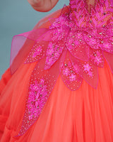 coral and fuchsia pink party wear gown with heavy and crafted yoke and petal detailing