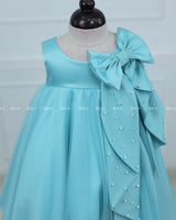 Sleeveless Aqua Frock With A Pearl-Detailed Bow And Flared Hem