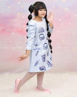 Light Blue A-Line Top With Printed Blue Motifs, Pearl Accents, And An Embroidered Neck.