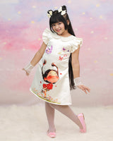Cream Peter Pan Collar Dress With Cartoon Print And Frilled Sleeves.