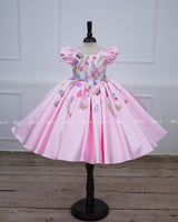 Baby pink floral frock with puff sleeves and handworked butterfly with bow