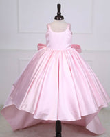 Princess-style pink gown with a flowing trail and large back bow.