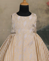 Ivory Frock With Brocade Bodice, Embellished Waist Highlights And Pleated Striped Flare