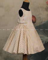 Ivory Frock With Brocade Bodice, Embellished Waist Highlights And Pleated Striped Flare