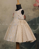 Ivory Frock With Brocade Bodice, Embellished Waist Highlights And Pleated Striped Flare