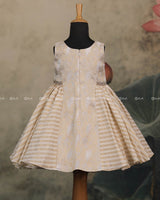 Ivory Frock With Brocade Bodice, Embellished Waist Highlights And Pleated Striped Flare