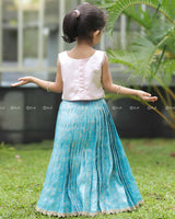 Sleeveless Pink Top With Floral Print And Pearls, Paired With Pleated Blue Brocade Skirt And Golden Lace Hem