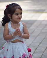 White Crop Top Pearl Beads Paired With A Flared Skirt Featuring Vibrant Pink Floral Embroidery