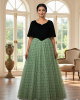 Dark Forest Green velvet sweetheart gown with flowy sleeves and a mint heart-mesh flare.