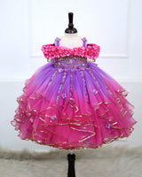 A Dreamy Cold-Shoulder Ball Gown with Flowing Layers of Lavender and Pink Tulle.