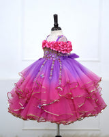 A Dreamy Cold-Shoulder Ball Gown with Flowing Layers of Lavender and Pink Tulle.