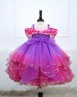 A Dreamy Cold-Shoulder Ball Gown with Flowing Layers of Lavender and Pink Tulle.