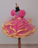 Flamingo Pink Twirled Gown Embellished with Artificial Flowers and Greenish Blue Petals