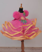 Flamingo Pink Twirled Gown Embellished with Artificial Flowers and Greenish Blue Petals