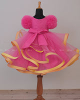 Flamingo Pink Twirled Gown Embellished with Artificial Flowers and Greenish Blue Petals