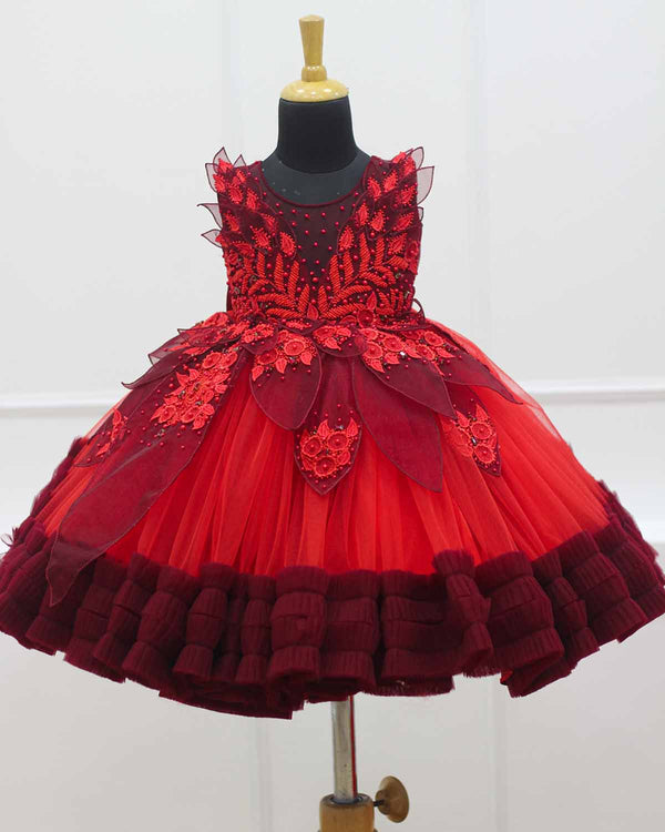 Red and maroon party wear gown with heavy and crafted yoke and petal detailing