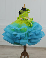 Lime Green & Turquoise Blue Twirled Gown with Multicolored Pastel Flower Embellished Yoke & Hcrafted Bow