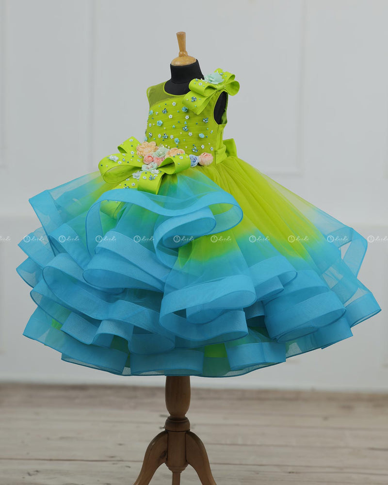 Lime Green & Turquoise Blue Twirled Gown with Multicolored Pastel Flower Embellished Yoke & Hcrafted Bow