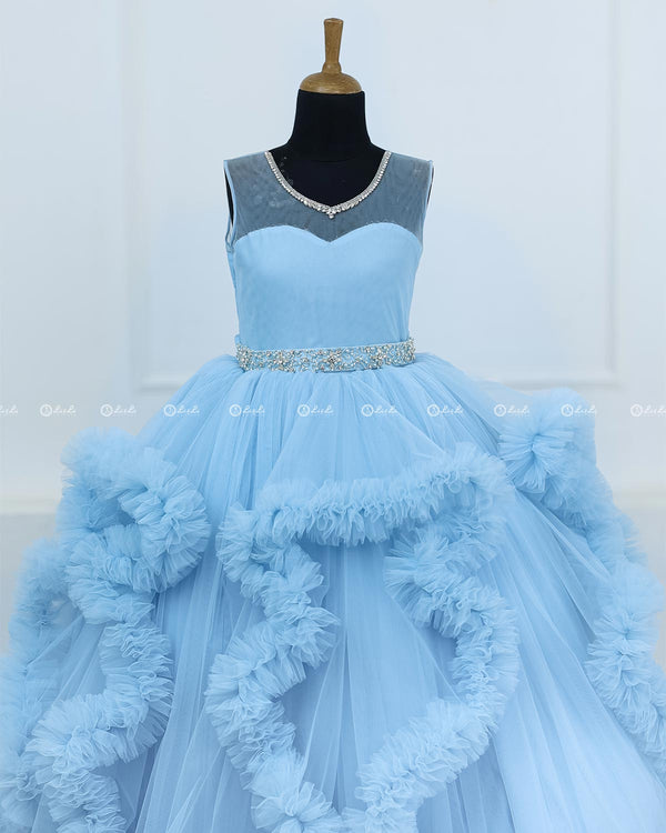 Elegant Sky Blue Ball Gown With Ruffle Detailing And Diamond Belt.