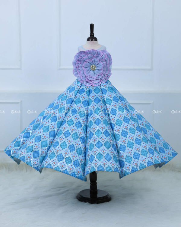 Lavender and Sky Blue Sleeveless Top With A Flower Accent, Paired With Flared Blue Printed Panel Skirt For A Stylish Party Look