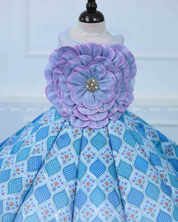 Lavender and Sky Blue Sleeveless Top With A Flower Accent, Paired With Flared Blue Printed Panel Skirt For A Stylish Party Look