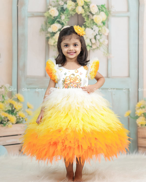 White Bodice Dress With Chick Print And Layered Yellow-Orange Feathered Gown