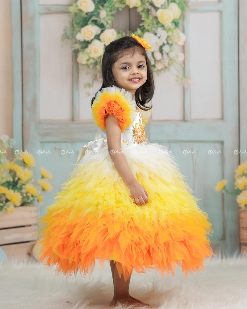 White Bodice Dress With Chick Print And Layered Yellow-Orange Feathered Gown