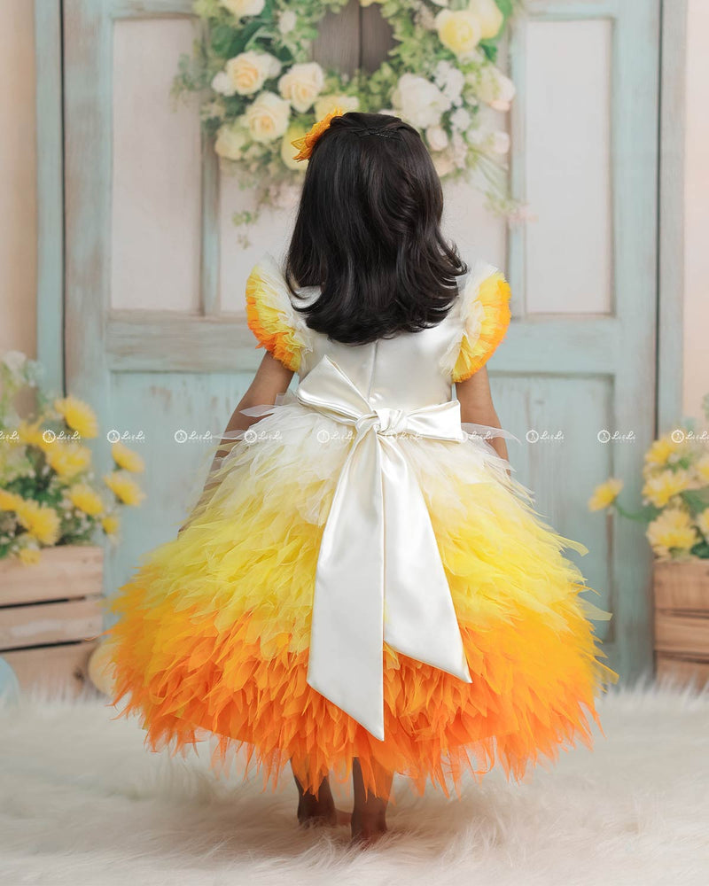 White Bodice Dress With Chick Print And Layered Yellow-Orange Feathered Gown