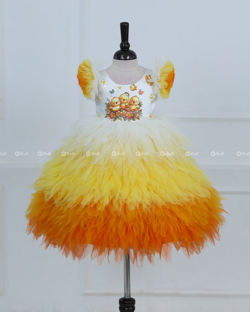 White Bodice Dress With Chick Print And Layered Yellow-Orange Feathered Skirt