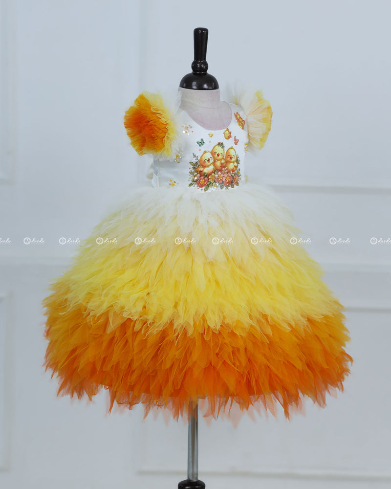 White Bodice Dress With Chick Print And Layered Yellow-Orange Feathered Skirt