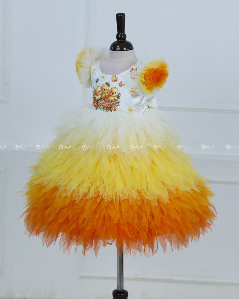 White Bodice Dress With Chick Print And Layered Yellow-Orange Feathered Skirt
