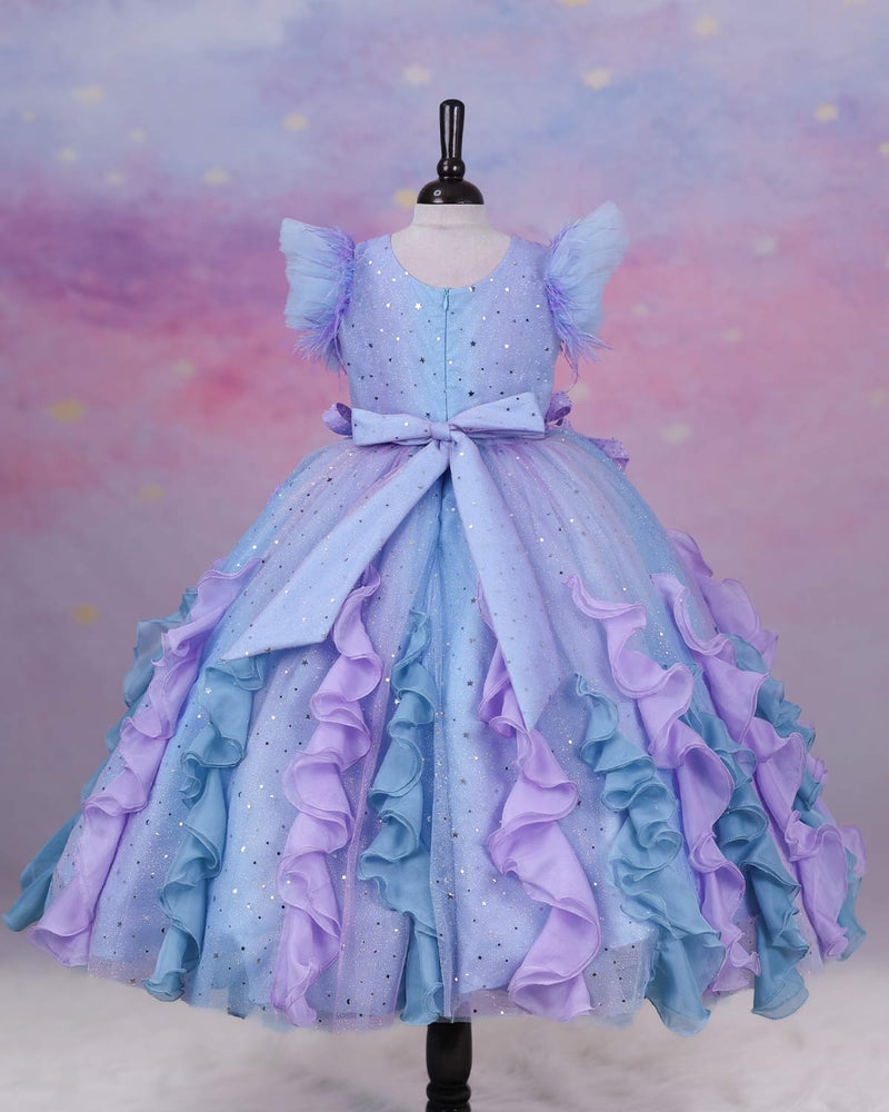 A dreamy lilac-blue fairy gown with butterfly details, side bows, and sparkling ruffles.