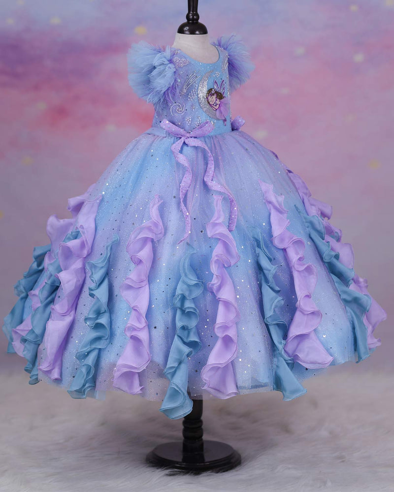 A dreamy lilac-blue fairy gown with butterfly details, side bows, and sparkling ruffles.
