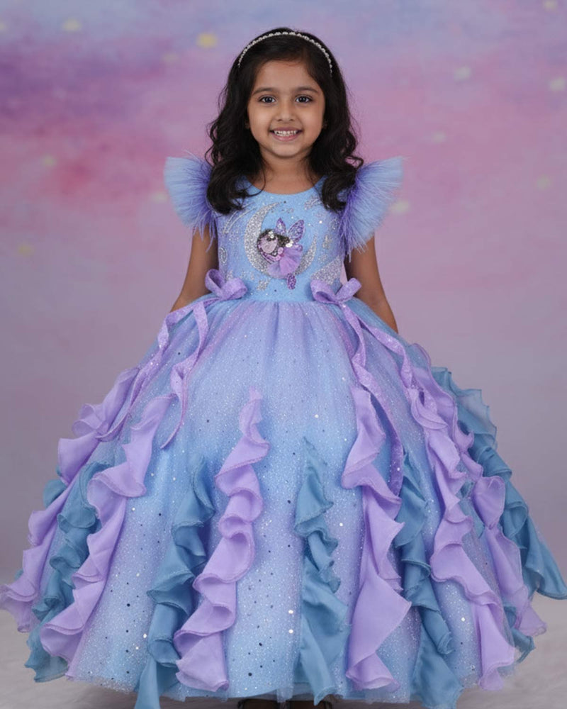 A dreamy lilac-blue fairy gown with butterfly details, side bows, and sparkling ruffles.
