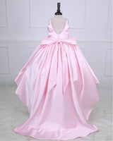 Princess-style pink gown with a flowing trail and large back bow.