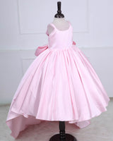 Princess-style pink gown with a flowing trail and large back bow.