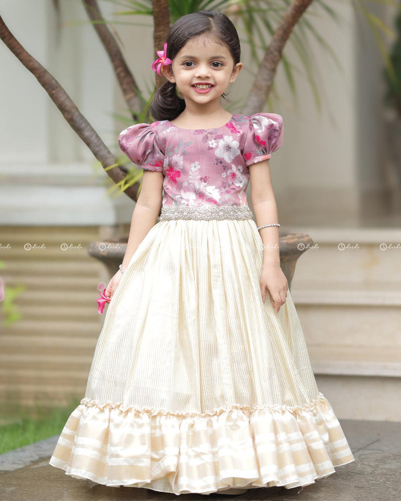 Mauve Floral Puff-Sleeve Top With Lace Hem, Paired With Cream Flared Skirt Featuring Golden Stripes And Ruffle Border