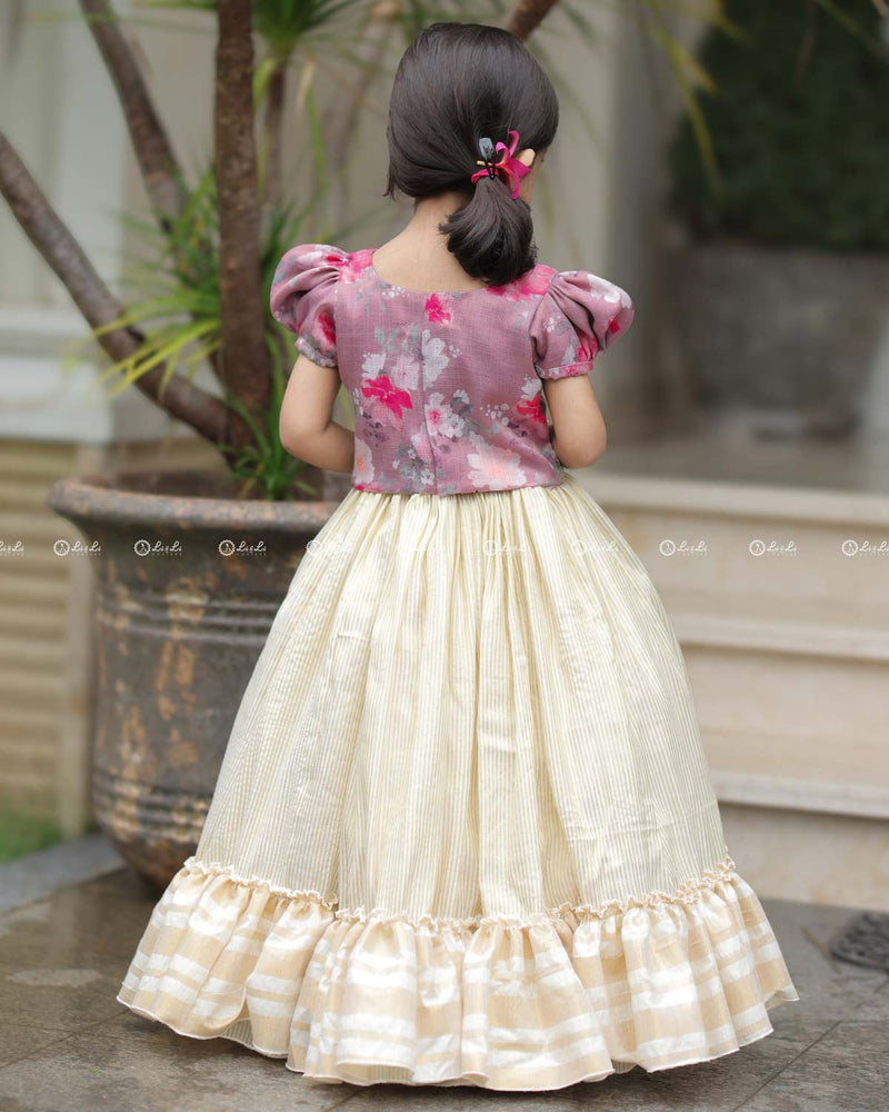 Mauve Floral Puff-Sleeve Top With Lace Hem, Paired With Cream Flared Skirt Featuring Golden Stripes And Ruffle Border