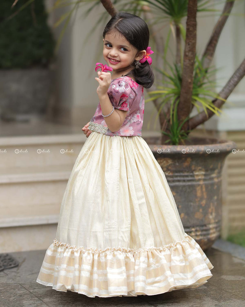 Mauve Floral Puff-Sleeve Top With Lace Hem, Paired With Cream Flared Skirt Featuring Golden Stripes And Ruffle Border
