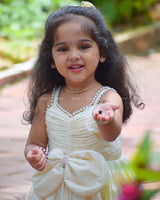 Ivory Frock With Pearl Neckline, Ruched Yoke, Waist Bow And Floral Woven Border