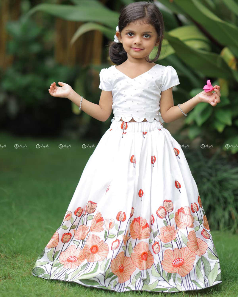 White Scallop Top With Pearl Beads, Paired With A Floral Poppy Print Skirt