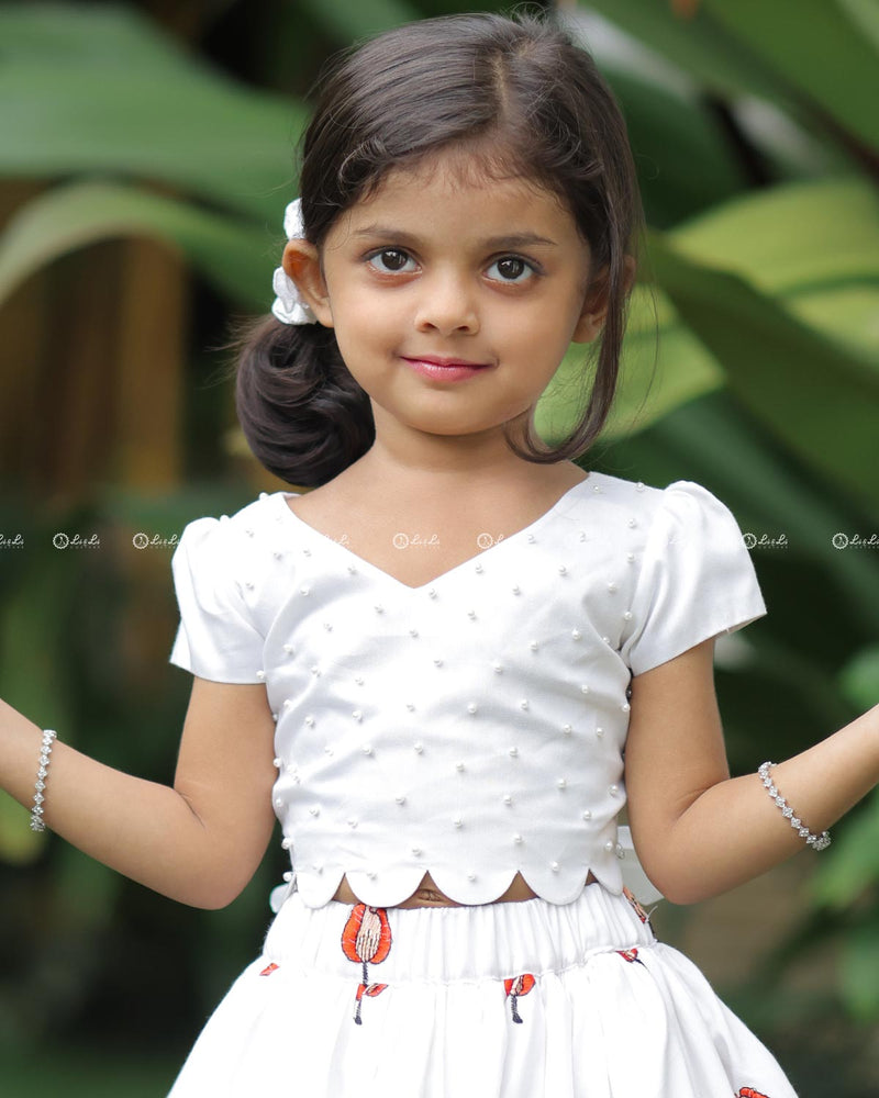 White Scallop Top With Pearl Beads, Paired With A Floral Poppy Print Skirt