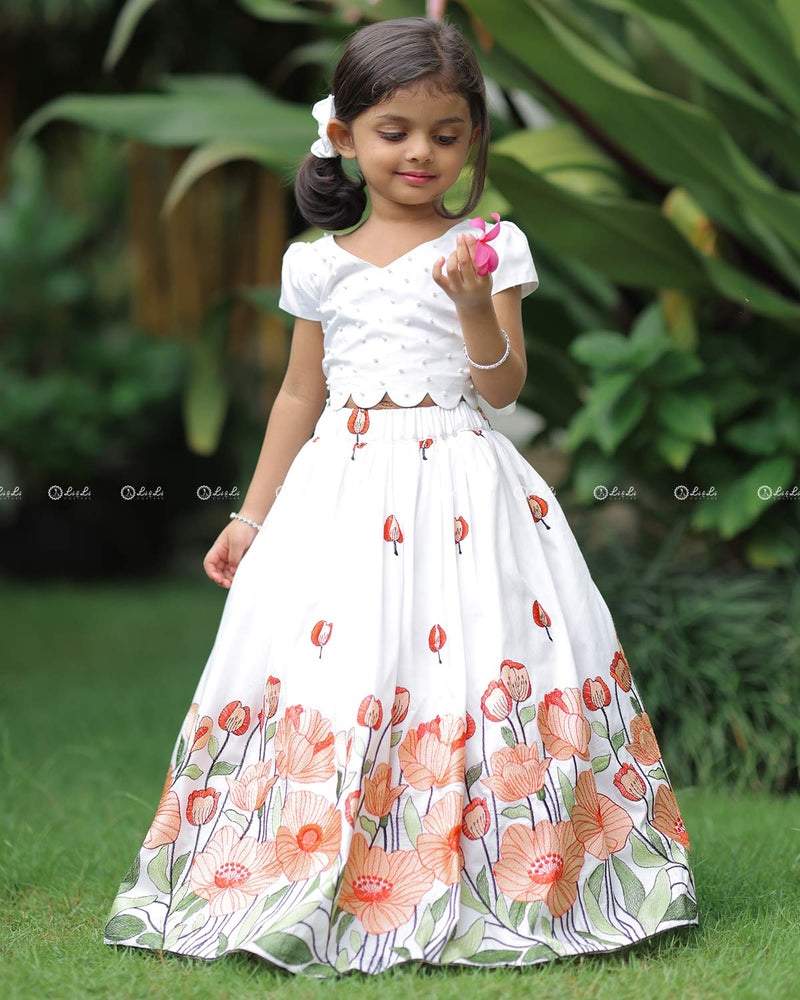 White Scallop Top With Pearl Beads, Paired With A Floral Poppy Print Skirt