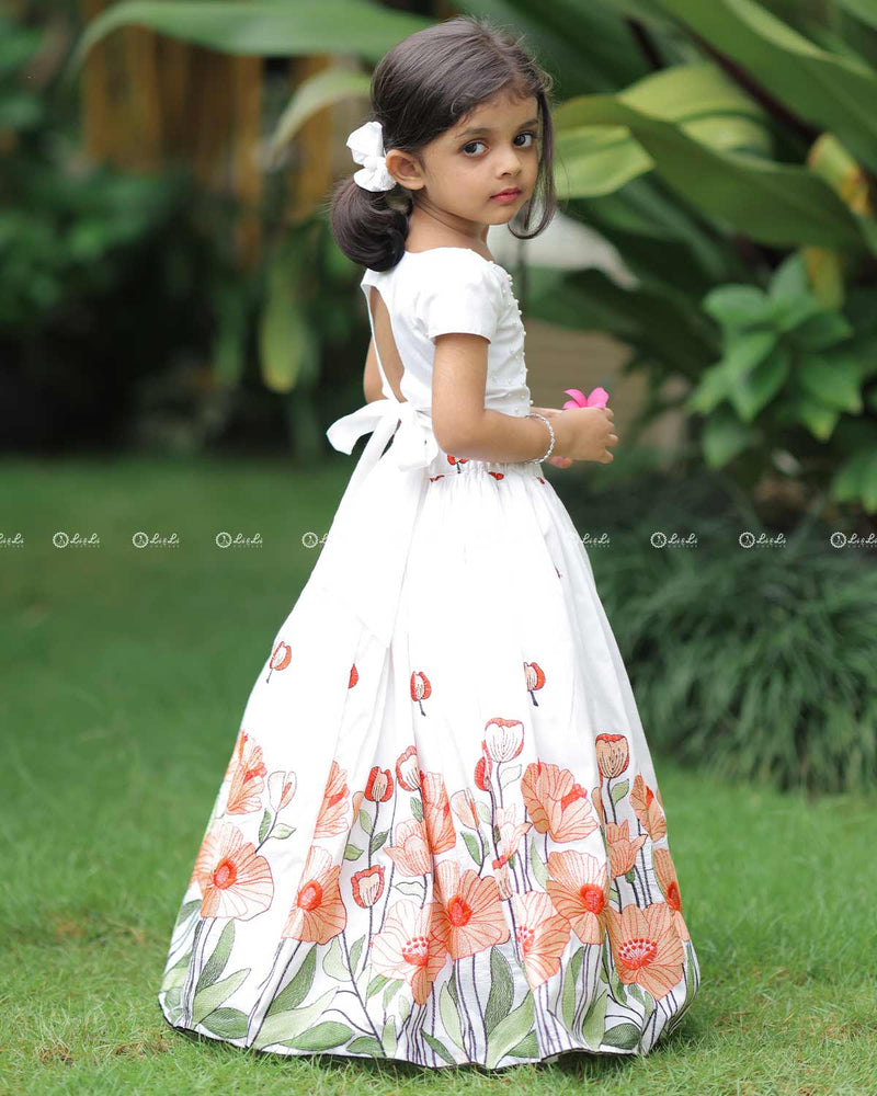 White Scallop Top With Pearl Beads, Paired With A Floral Poppy Print Skirt